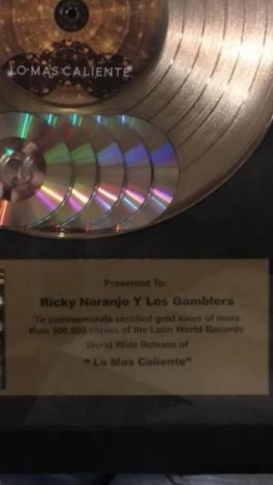 presented to Ricky Naranjo y Los Gamblers to commemorate gold sales of more than 500,000 copies of the Latin World Records World Wide Release of "Lo Mas Caliente"